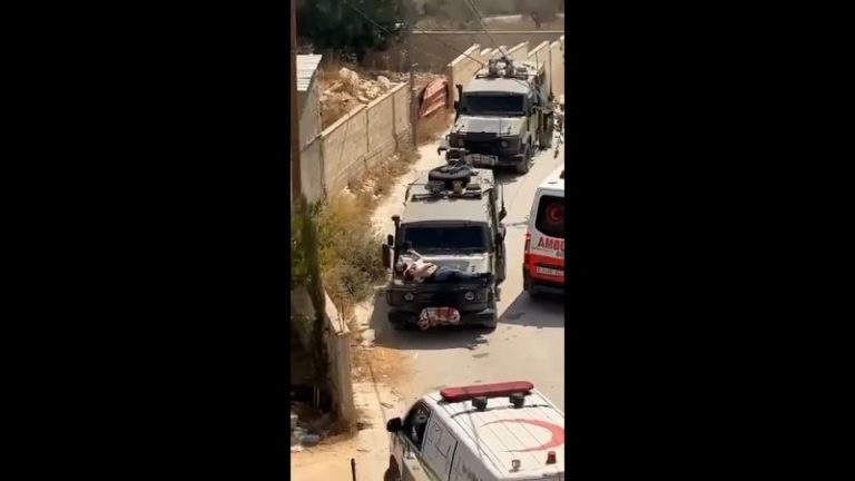 Israeli military straps injured Palestinian man to hood of jeep