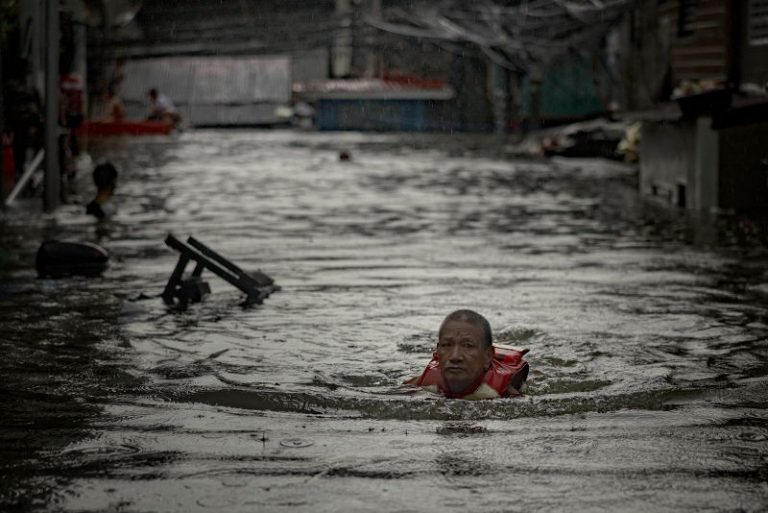 Thousands stranded by floods in Philippine capital as deadly typhoon prompts calls for climate action